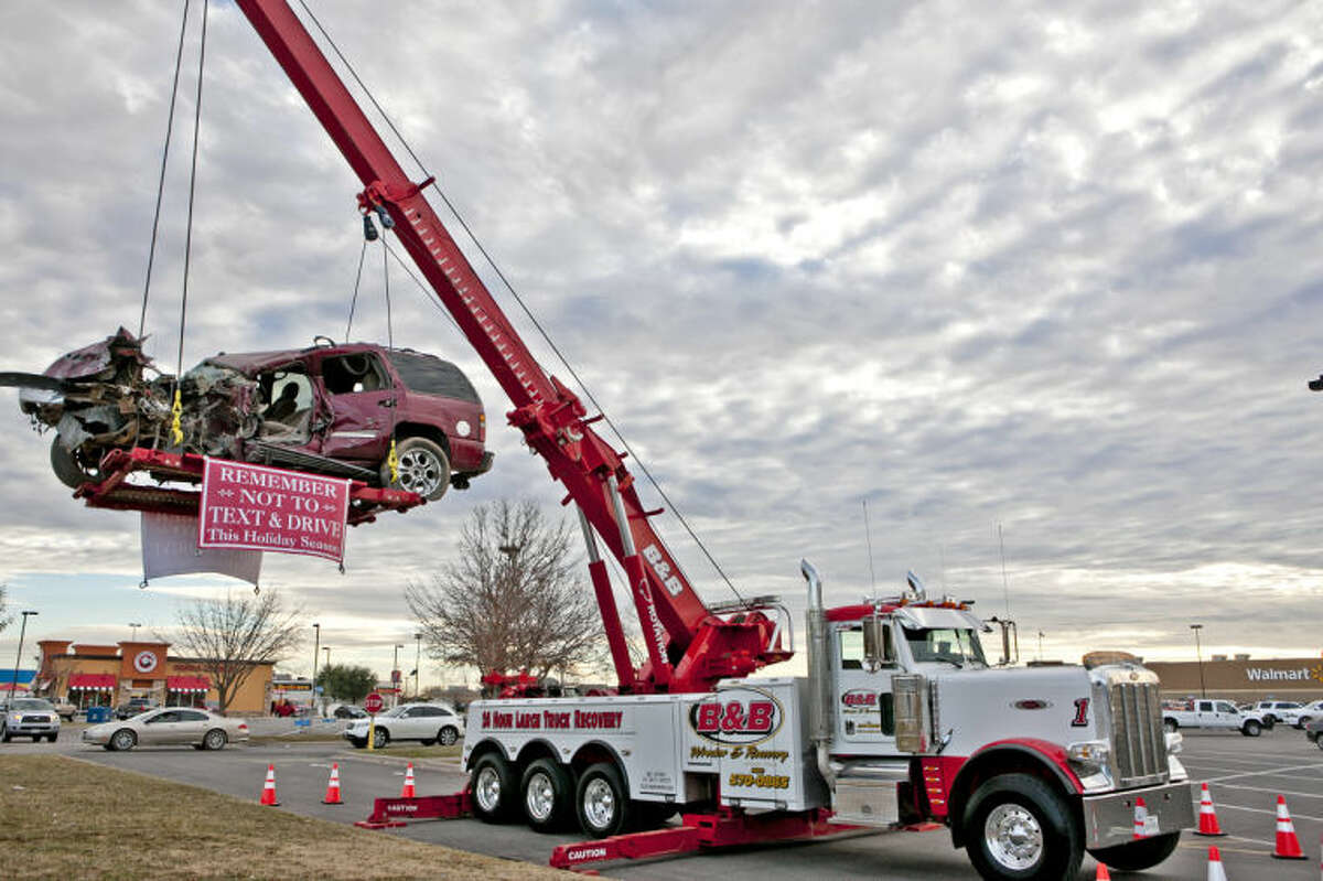 (File Photo) B&B Wrecker & Recovery put up a reminder to not text or drink and drive outside the north side Wal-Mart Nov. 30, 2014. James Durbin/Reporter-Telegram