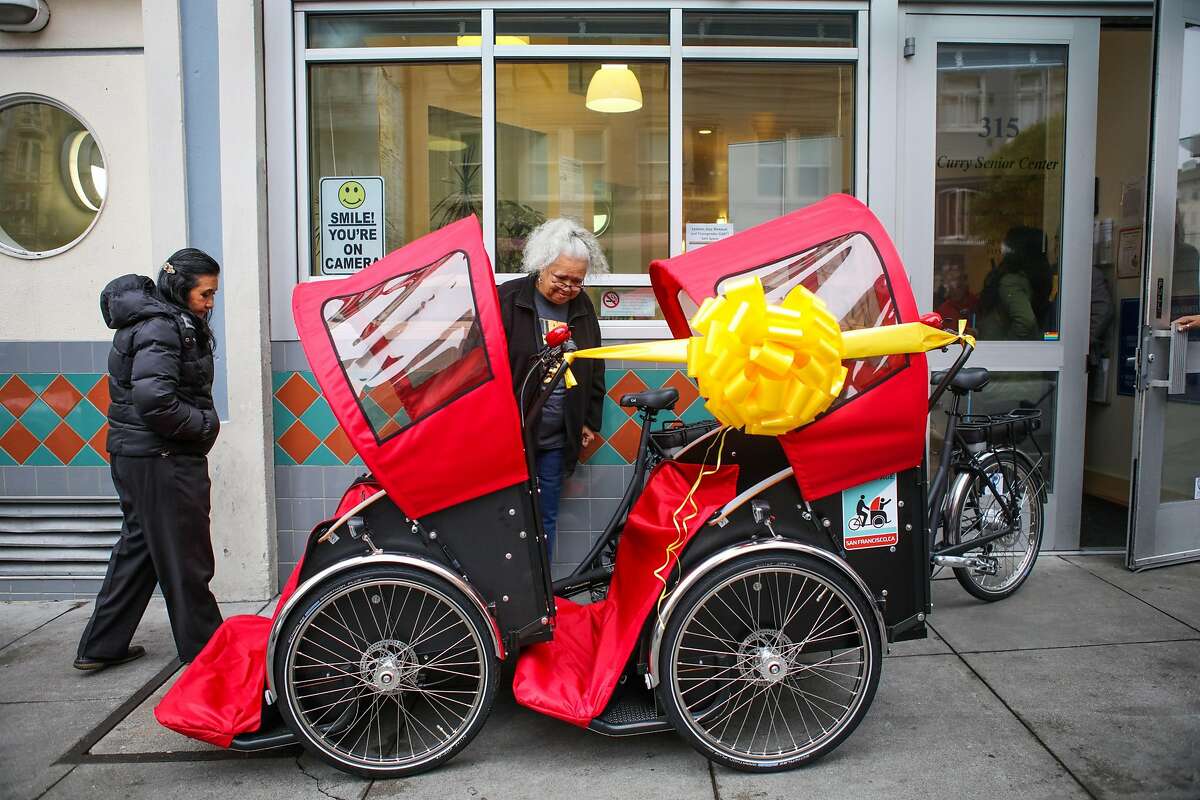 (l-r) Teresita Lahiff and Diane Evans take a look at tricycle rickshaws that were donated to the Curry Senior Center by Zendesk, in San Francisco, California, on Friday, May 6, 2016.