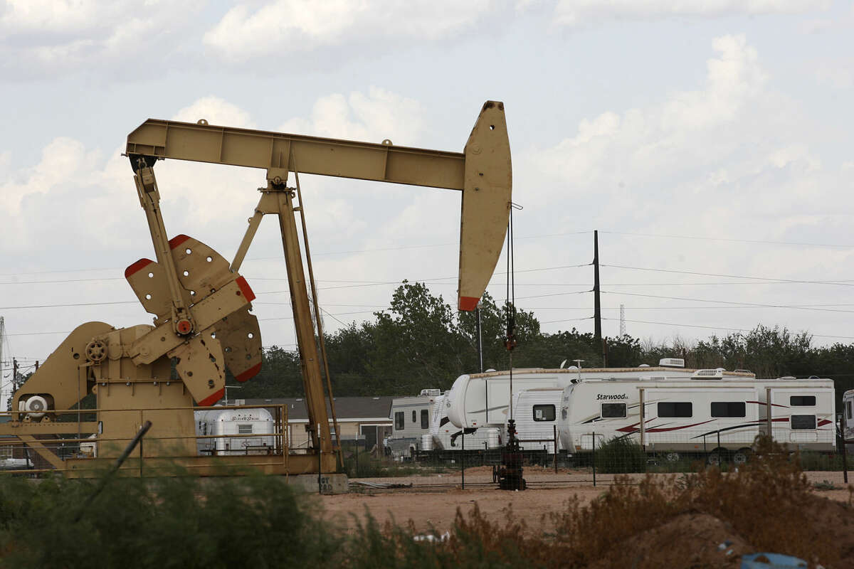 An RV park is located near a pump jack in Midland, Texas, Wednesday, July 25, 2012.