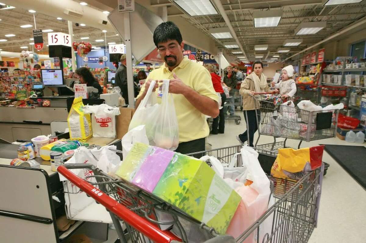 Sid Rodriguez sacks grocries for customers Friday at HEB. HEB will be open Christmas Eve form 6 am to 8 pm and closed Christmas Day. Cindeka Nealy/Reporter-Telegram