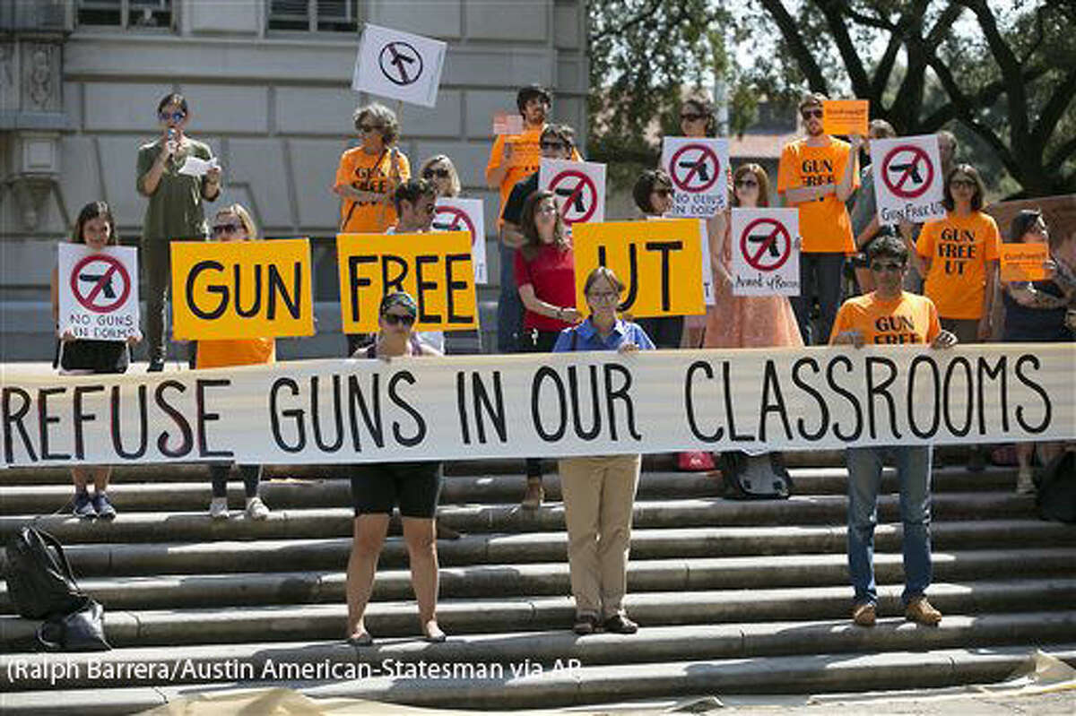 FILE - In this Oct. 1, 2015, file photo, protesters gather on the West Mall of the University of Texas campus to oppose a new state law that expands the rights of concealed handgun license holders to carry their weapons on public college campuses. University of Texas President Greg Fenves has approved rules that will allow concealed handgun license holders to bring their weapons into classrooms. State law requires public universities to allow concealed handguns in classrooms and buildings starting Aug. 1, 2016, but also gives campuses some leeway to carve out gun-free zones. (Ralph Barrera/Austin American-Statesman via AP, File) AUSTIN CHRONICLE OUT, COMMUNITY IMPACT OUT, INTERNET AND TV MUST CREDIT PHOTOGRAPHER AND STATESMAN.COM, MAGS OUT; MANDATORY CREDIT