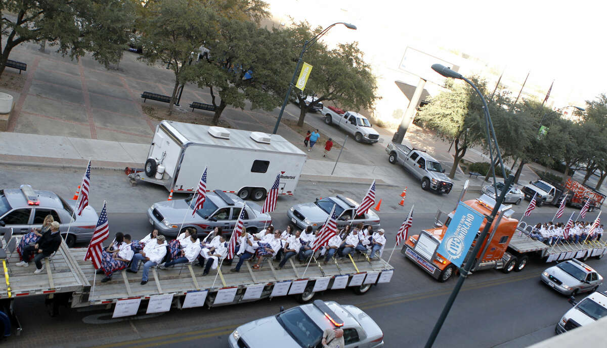 PREVIOUSLY UNRELEASED FILE PHOTO / Flatbed trucks carrying wounded veterans and their families drive down Wall Street during the Show of Support parade Nov. 15 in Midland. The flatbed truck on the far right of the image was struck by a train at a crossing on Garfield St., killing four and injuring 14. James Durbin/Reporter-Telegram