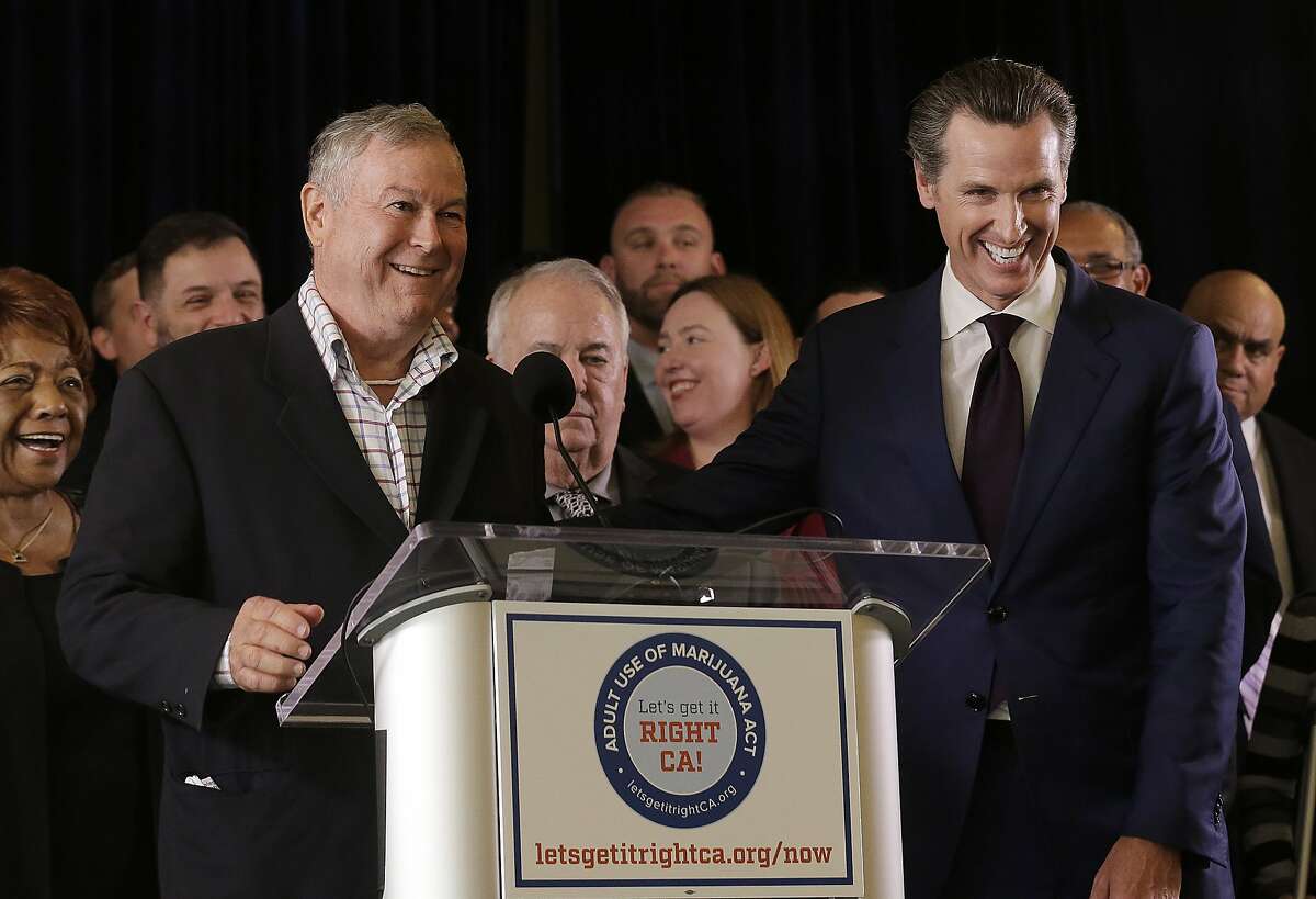 Rep. Dana Rohrabacher, R-Calif., left, smiles next to Lt. Gov. Gavin Newsom at a news conference after speaking in support of the Adult Use of Marijuana Act ballot measure in San Francisco, Wednesday, May 4, 2016. Backers of a marijuana legalization initiative said Wednesday they have collected enough signatures for the measure to qualify for the November ballot in California. (AP Photo/Jeff Chiu)