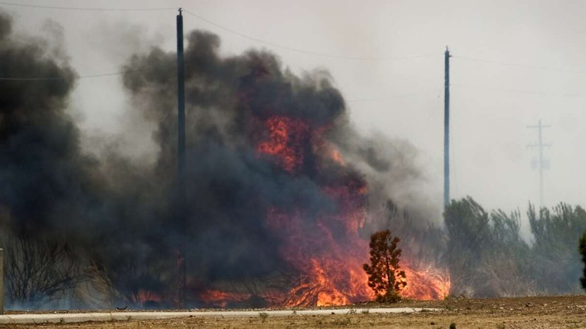 (FILE PHOTO) Tall dry grasses and high winds make fires difficult to contain.