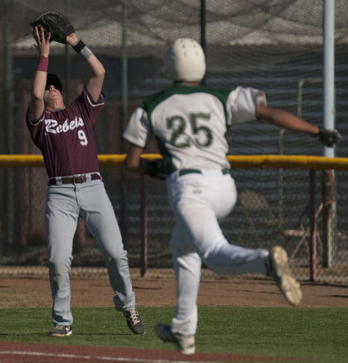 Lee High's Blake Blessie catches a pop foul for the out as El PAso Montwood's Sergio Gonzalez runs to first Friday afternoon at Christensen Stadium during the Tournament of Champions. Tim Fischer\Reporter-Telegram