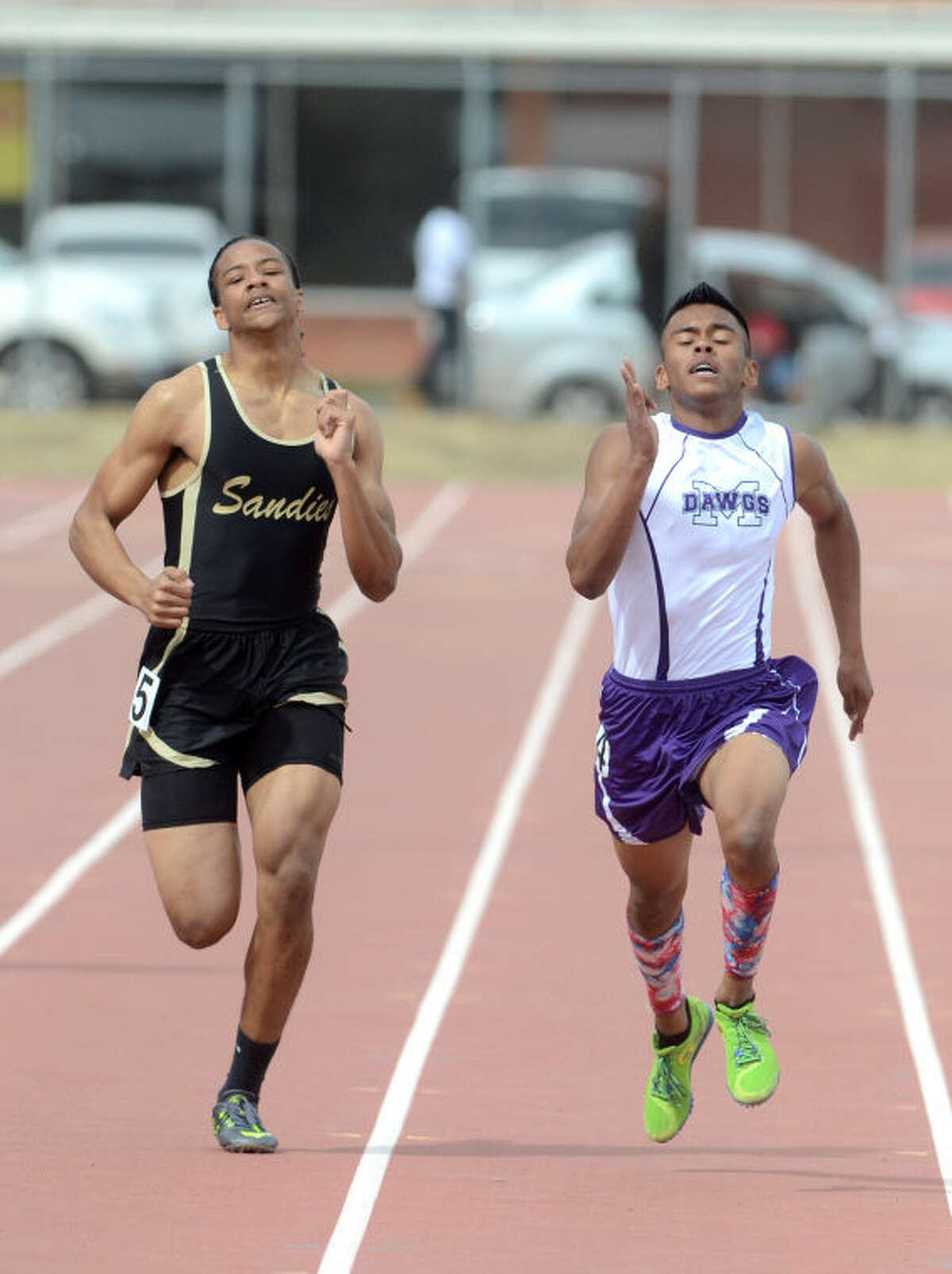Midland High's Nick Garcia (right) competes against Amarillo High's Treyvon Martin in the 400 during the Rogers Ford Lincoln Tall City Invitational on Saturday at Memorial Stadium. Garcia won the event with a time of 51.28. James Durbin/Reporter-Telegram