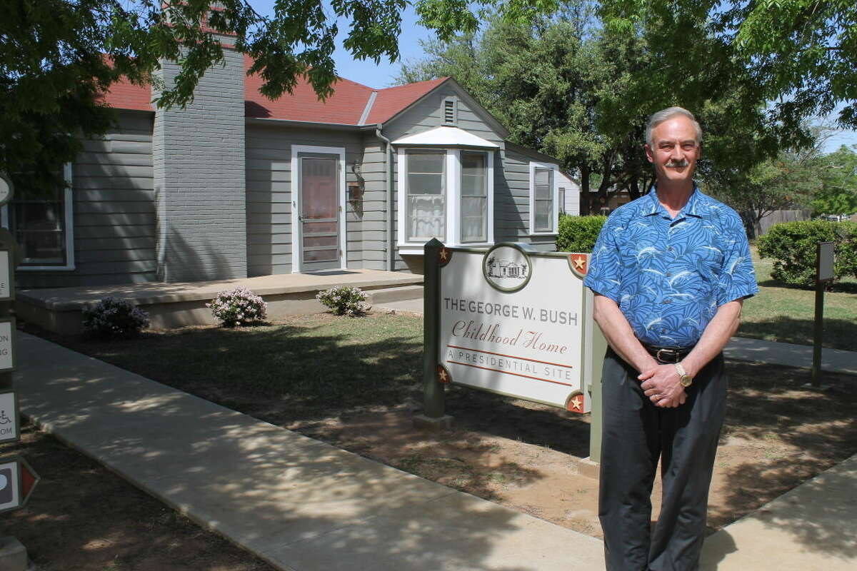 Executive director Paul St. Hilaire stands in front of the Bush home before their 10th anniversary celebration.