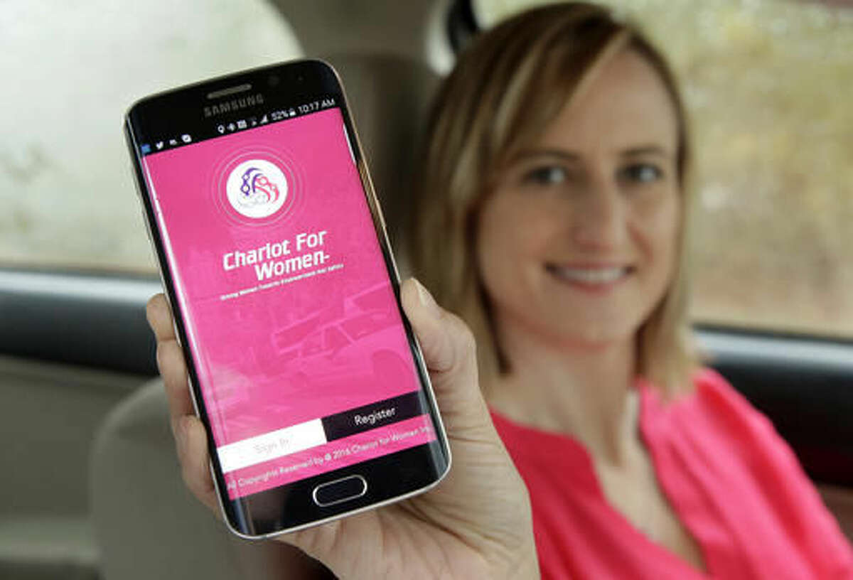 In this Thursday, April 7, 2016 photo Kelly Pelletz, of Charlton, Mass., co-creator of the ride-sharing service Chariot for Women, displays the app on a mobile phone, in Charlton. Kelly and her husband Michael Pelletz are launching the service this summer, featuring female drivers picking up solely women and children passengers. (AP Photo/Steven Senne)