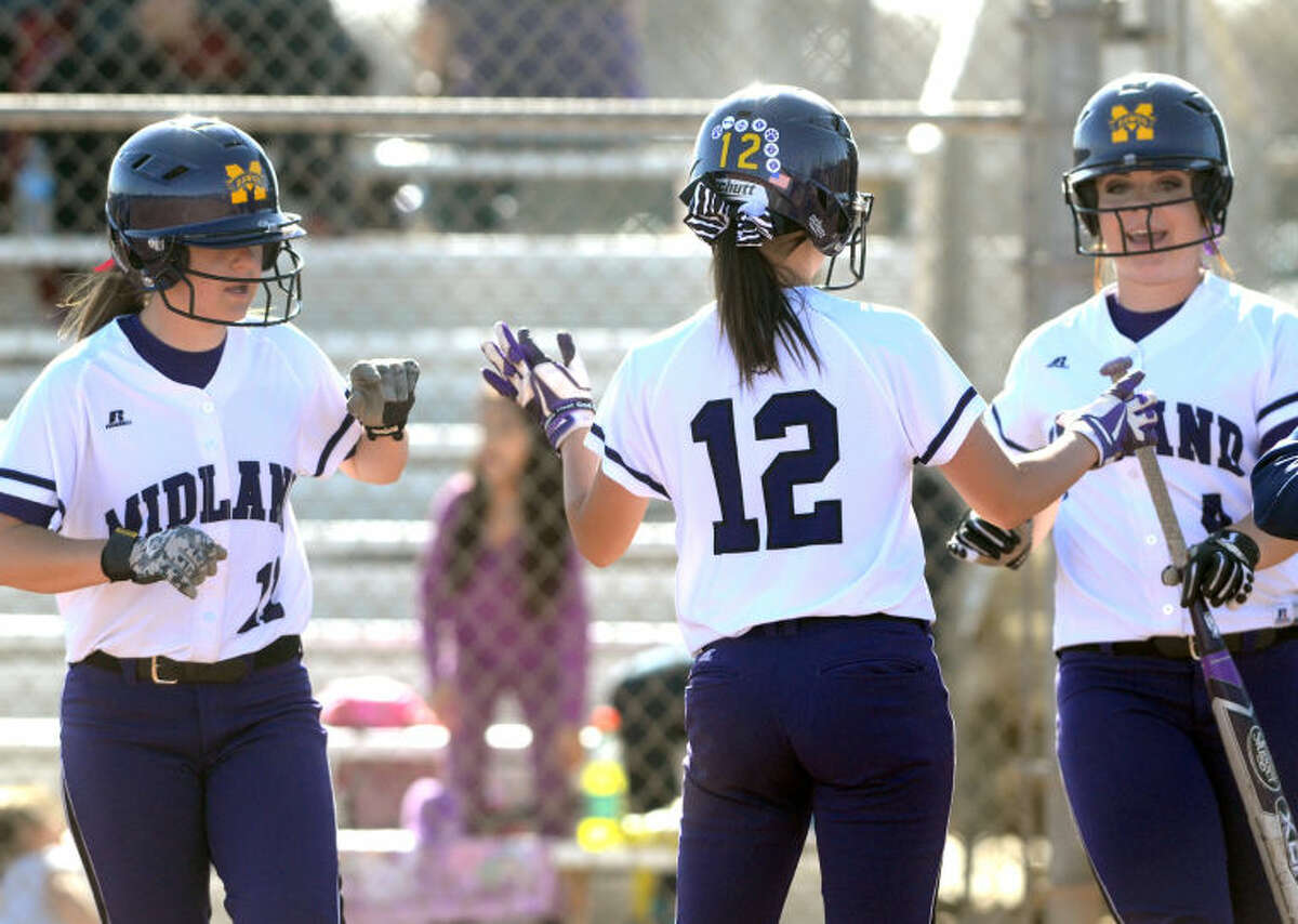 Midland High's Aubree Rowley (11), Brittany Baggett (12) and Sydney Betcher (4) celebrate runs scored against San Angelo Central on Thursday at Audrey Gill Sports Complex. James Durbin/Reporter-Telegram