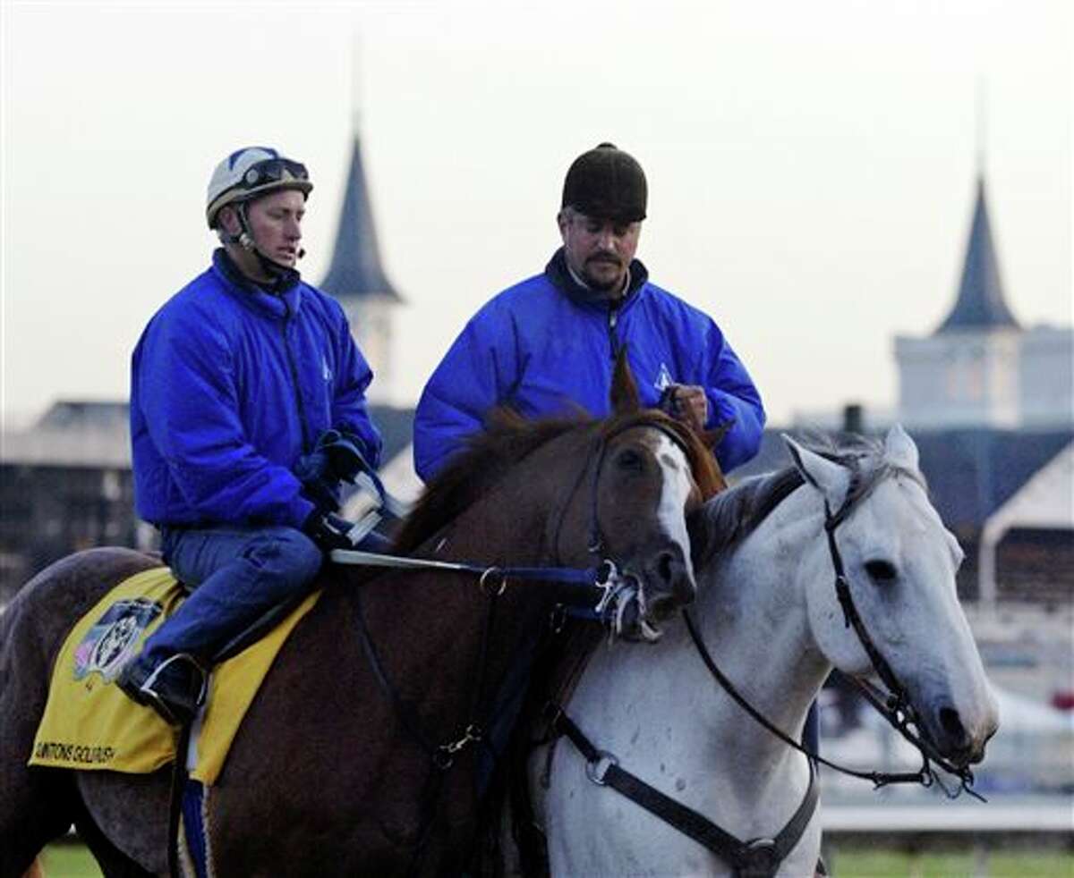 FILE - In this April 28, 2004, file photo, trainer Steve Asmussen, right, leads Kentucky Derby hopeful Quintons Gold Rush and exercise rider Scott Blasi off the track after a morning workout at Churchill Downs in Louisville, Ky. Thoroughbred racing regulators in New York and Kentucky are investigating allegations of mistreatment of horses by the Hall of Fame-nominated trainer and his top assistant. The states' racing commissions said Thursday, March 20, 2014, investigations were launched after People for the Ethical Treatment of Animals provided video evidence from an undercover investigation of Asmussen and associates. (AP Photo/Daniel P. Derella, File)