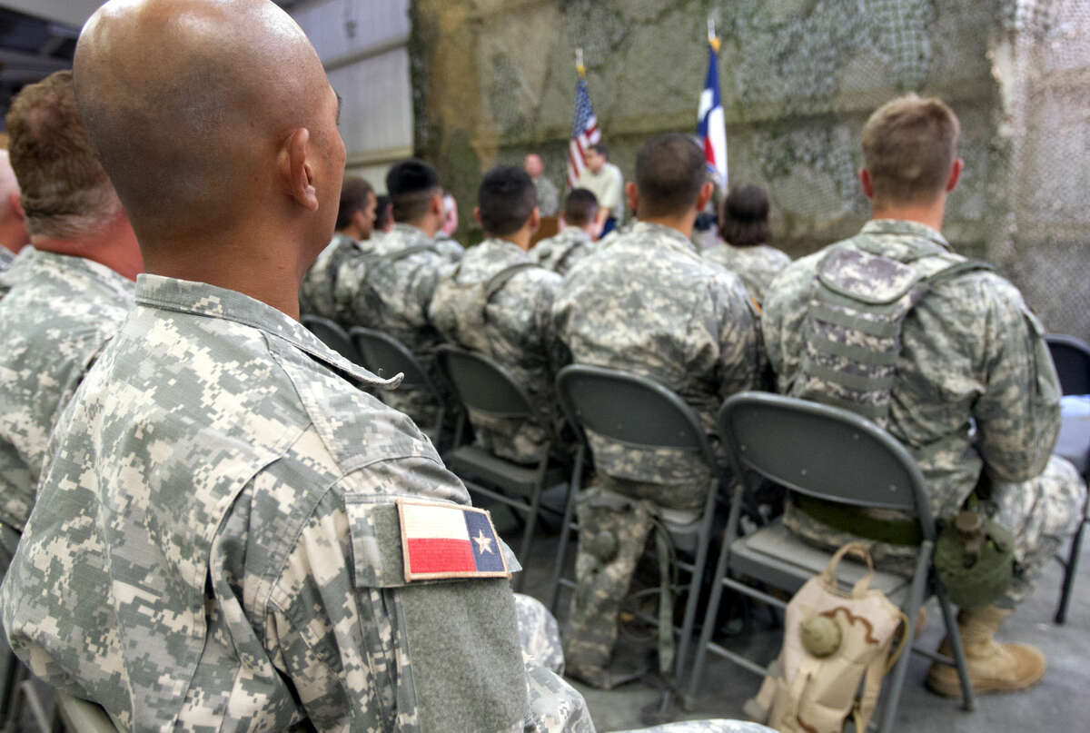 Texas State Guard troops listen to Gov. Rick Perry Wednesday Aug. 13, 2014 as he talks to troops training at Camp Swift near Bastrop.
