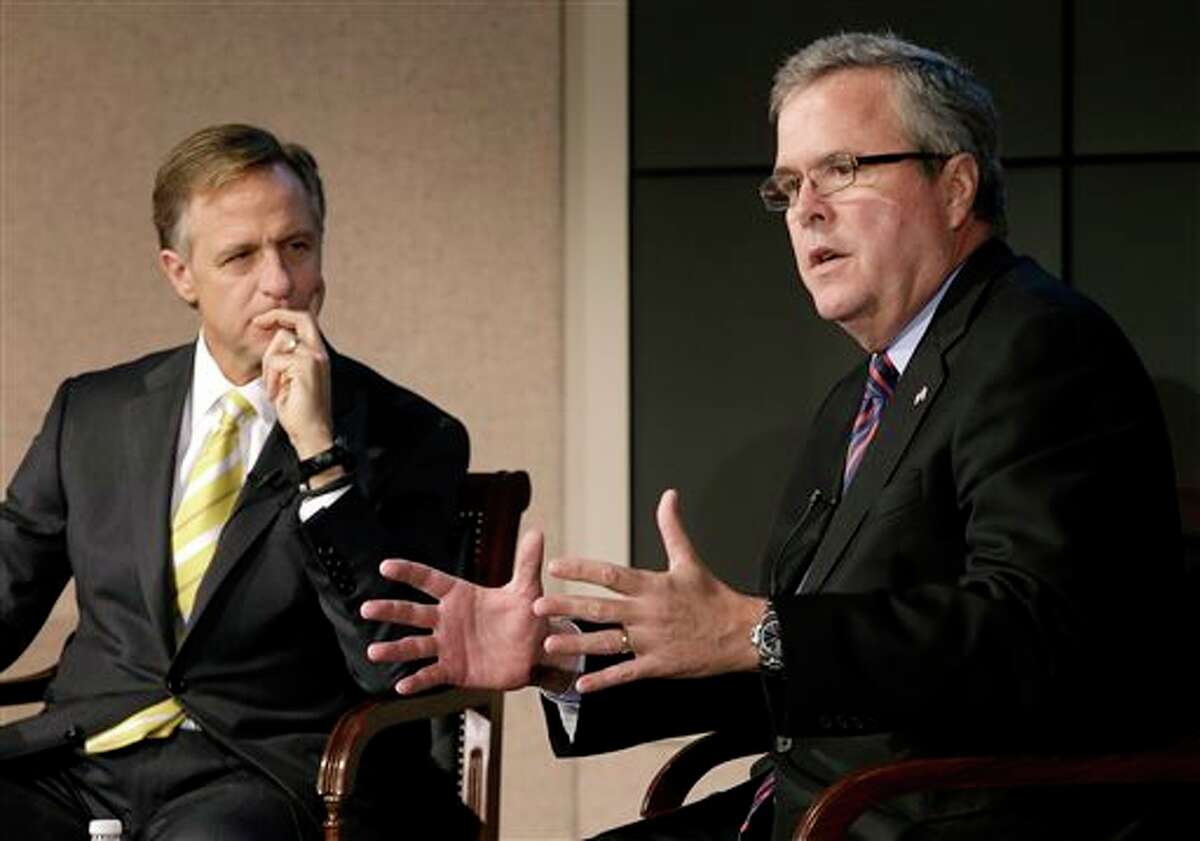 FILE - This Jan. 14, 2013 file photo shows former Florida Gov. Jeb Bush, right, and Tennessee Gov. Bill Haslam talking about education reform during a forum in Nashville, Tenn. More than five years after governors from both major parties began a mostly quiet effort to set new standards in American schools, the so-called Common Core initiative has morphed into a political tempest that fuels division among Republicans. Bush hails Common Core as a way to improve student performance and, over the long term, competitiveness of American workers. (AP Photo/Mark Humphrey, File)