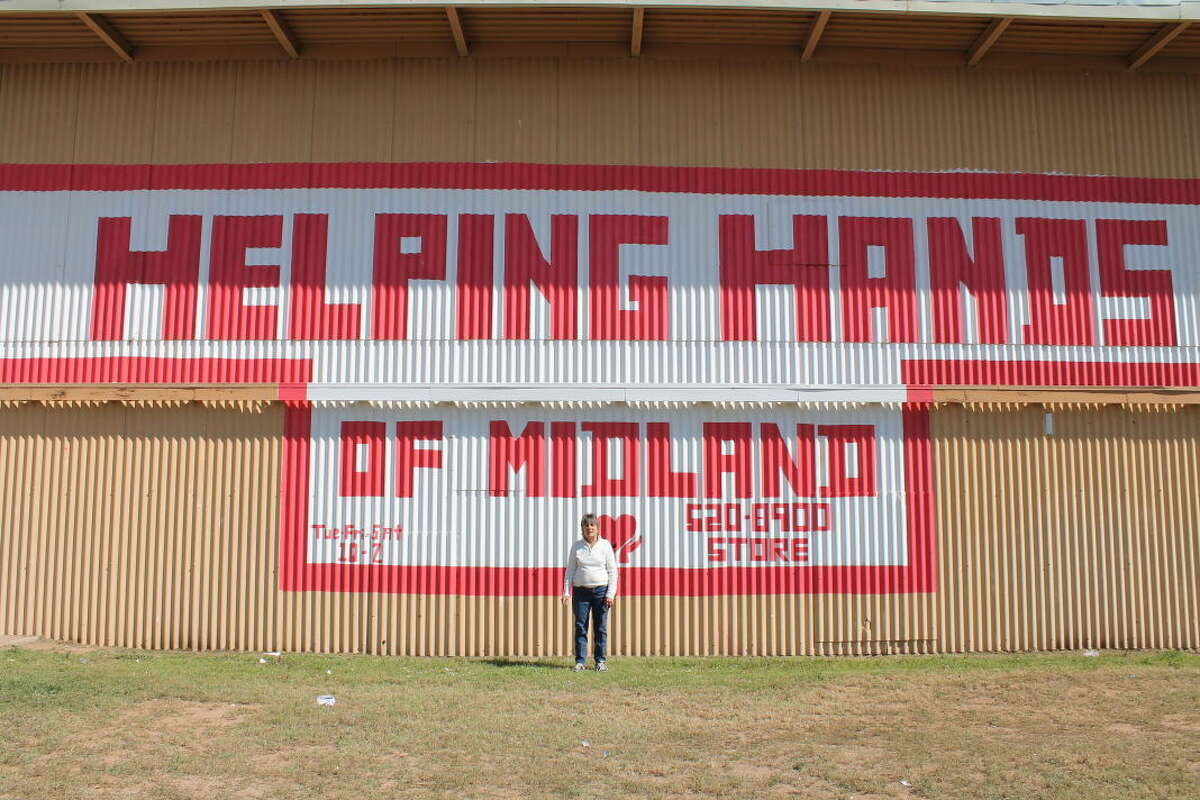Mary Hardin, executive director of Helping Hands, stands outside the nonprofit's building.
