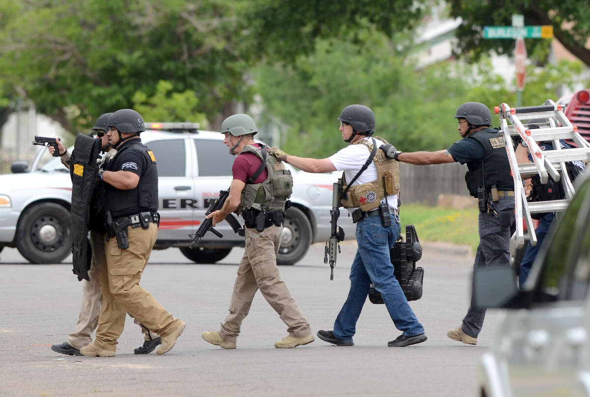 Midland public safety officials work the scene of an individual barricaded in a home on Thursday, April 23, 2015 near the intersection of Brunson and Garfield. James Durbin/Reporter-Telegram