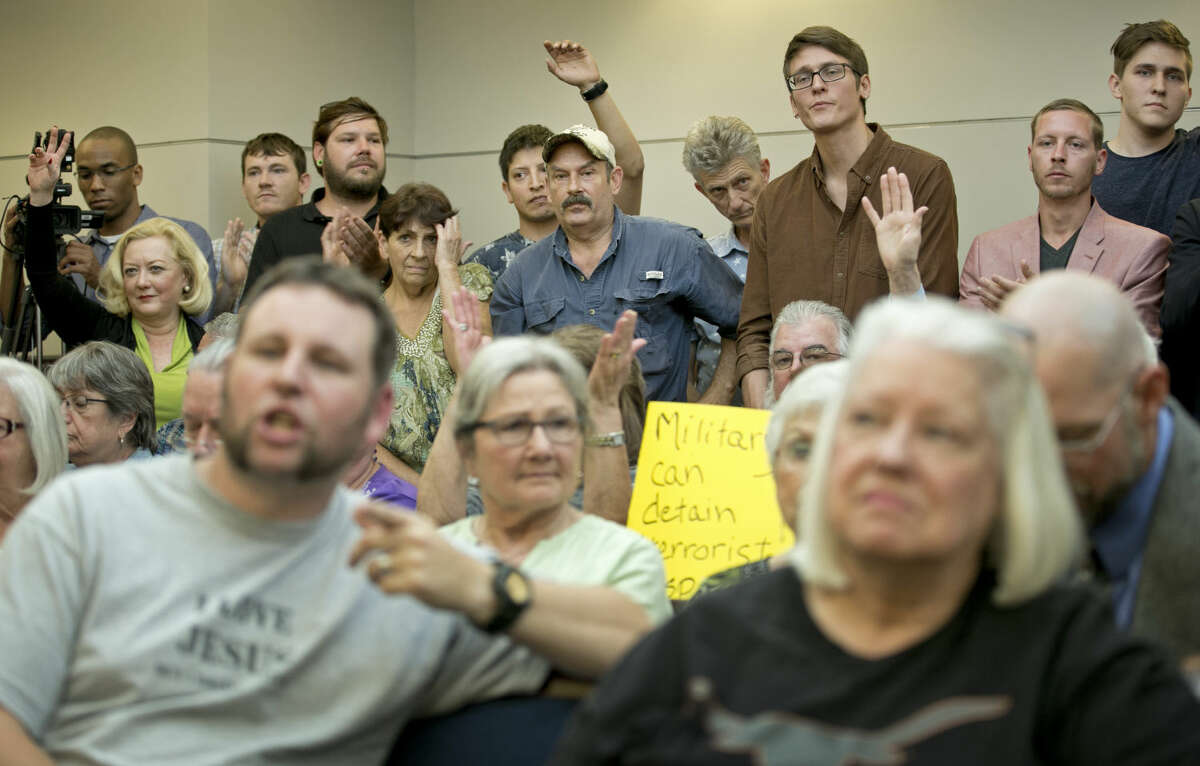 People listen at a public hearing about the Jade Helm 15 military training exercise in Bastrop, Texas, Monday April 27, 2015. (Jay Janner/Austin American-Statesman via AP) AUSTIN CHRONICLE OUT, COMMUNITY IMPACT OUT, INTERNET AND TV MUST CREDIT PHOTOGRAPHER AND STATESMAN.COM, MAGS OUT