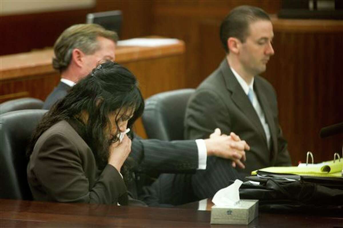 Ana Lilia Trujillo, left, reacts to hearing a 911 call during her trial Tuesday, April 1, 2014, in Houston. Trujillo, 45, is charged with murder, accused of killing her 59-year-old boyfriend, Alf Stefan Andersson with the heel of a stiletto shoe, at his Museum District high-rise condominium in June 2013. (AP Photo/Houston Chronicle, Brett Coomer) MANDATORY CREDIT