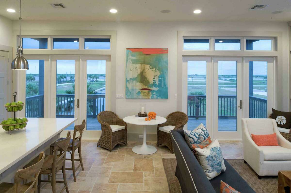 Houston interior designer Courtnay Tartt Elias nurtured a coastal vibe in this beach home, using soft neutrals, accents of blue and pops of orange.