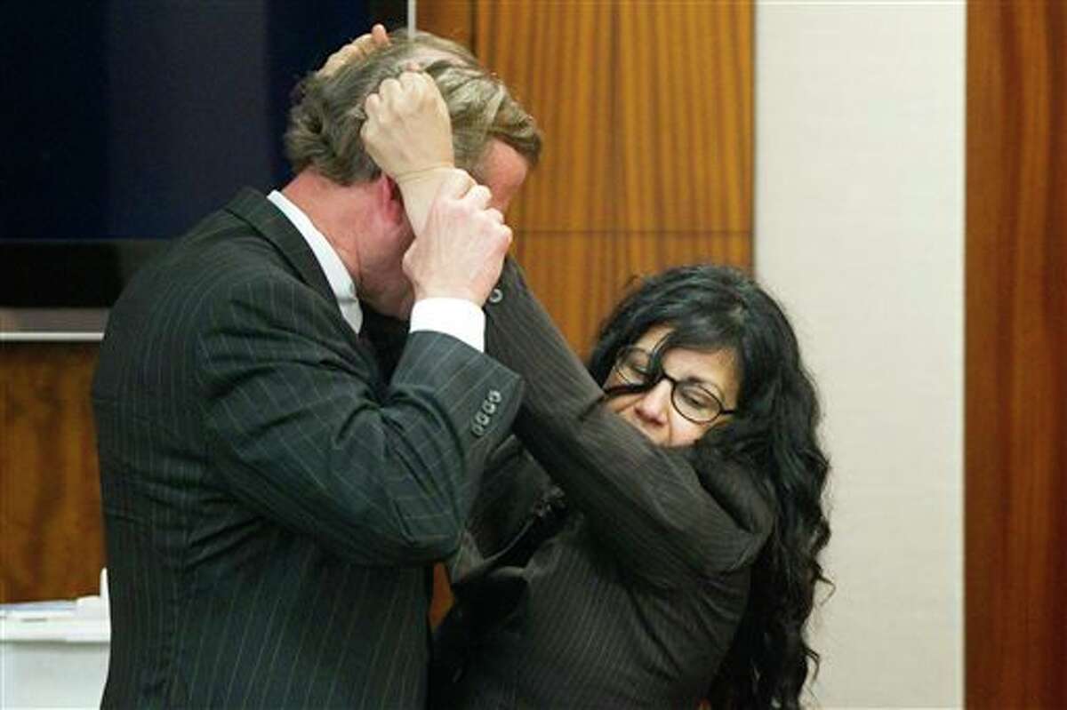 Defense attorney Jack Carroll, left, and Ana Trujillo demonstrate the fight that led to a fatal stabbing as she testifies during the punishment phase of her trial on Thursday, April 10, 2014, in Houston. Trujillo, convicted of murder for fatally stabbing her boyfriend 59-year-old Alf Stefan Andersson with a 5 ½-inch stiletto shoe heel, told the jurors she killed him in a desperate attempt to save her own life during a brutal fight of more than an hour in which she was chased down, knocked into a wall and thrown over a couch. (AP Photo/Houston Chronicle, Brett Coomer) MANDATORY CREDIT