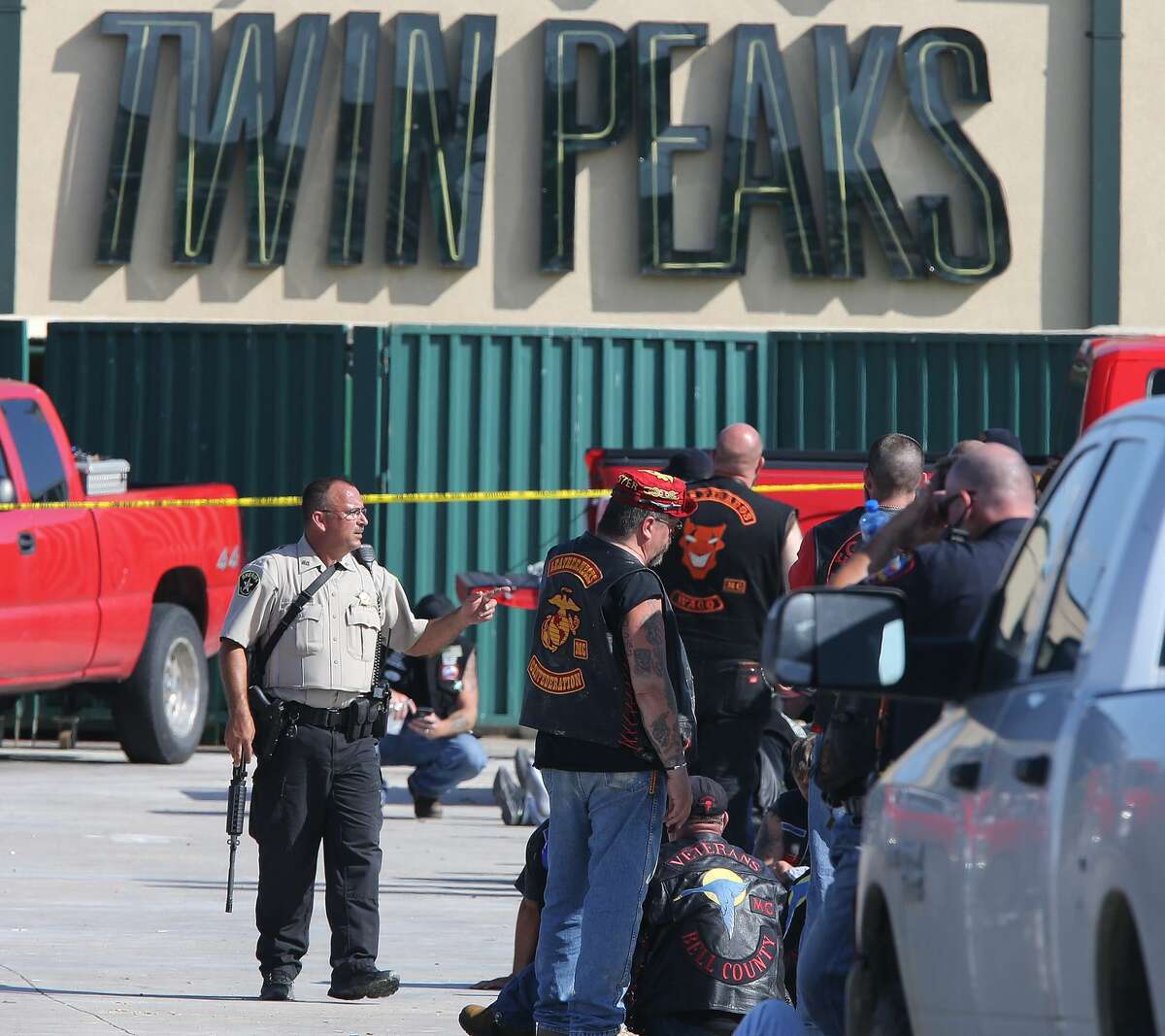 Authorities investigate a shooting in the parking lot of the Twin Peaks restaurant Sunday, May 17, 2015, in Waco, Texas. Authorities say that the shootout victims were members of rival biker gangs that had gathered for a meeting. (AP Photo/Jerry Larson)