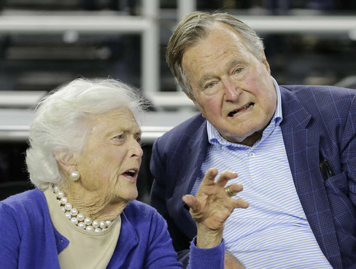 FILE- In this March 29, 2015, photo, former President George H.W. Bush and his wife Barbara Bush speak before the first half of a college basketball game in Houston. The former first lady is promoting literacy on her 90th birthday by lending her backing to a $7 million challenge by X Prize and Dollar General. They’re challenging developers to create a mobile app to help improve adult literacy skills. (AP Photo/David J. Phillip, File)