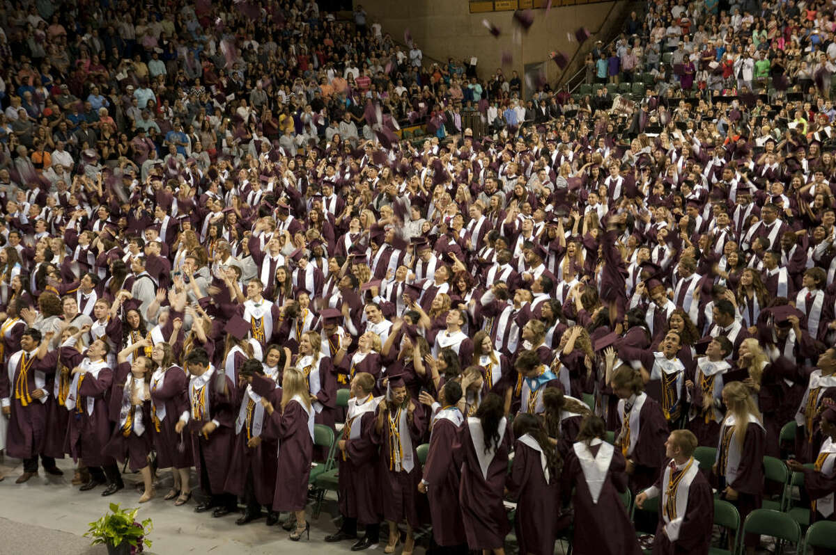 Lee High graduates toss their hats high in the air after receiving their diploma Saturday, 5-30-15, at the commencement ceremony at the Midland College Chaparral Center. Tim Fischer\Reporter-Telegram