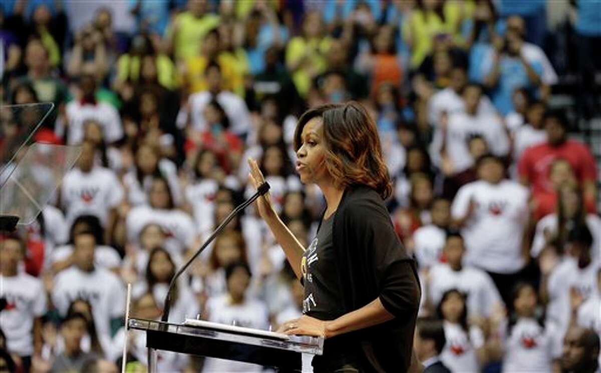 First lady Michelle Obama leads high school students in a pledge for higher education during College Signing Day, an annual celebration of San Antonio high school seniors committing themselves to higher education, Friday, May 2, 2014, in San Antonio. (AP Photo/Eric Gay)