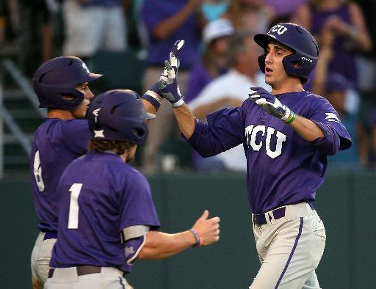 TCU's Nolan Brown (6) and Cody Jones (1) celebrate with Jeremie Fagnan, right, after scoring on a triple by Dane Steinhagen in the third inning against North Carolina State in an NCAA college baseball tournament regional game Sunday, May 31, 2015, in Fort Worth. (Richard W. Rodriguez/Fort Worth Star-Telegram via AP)