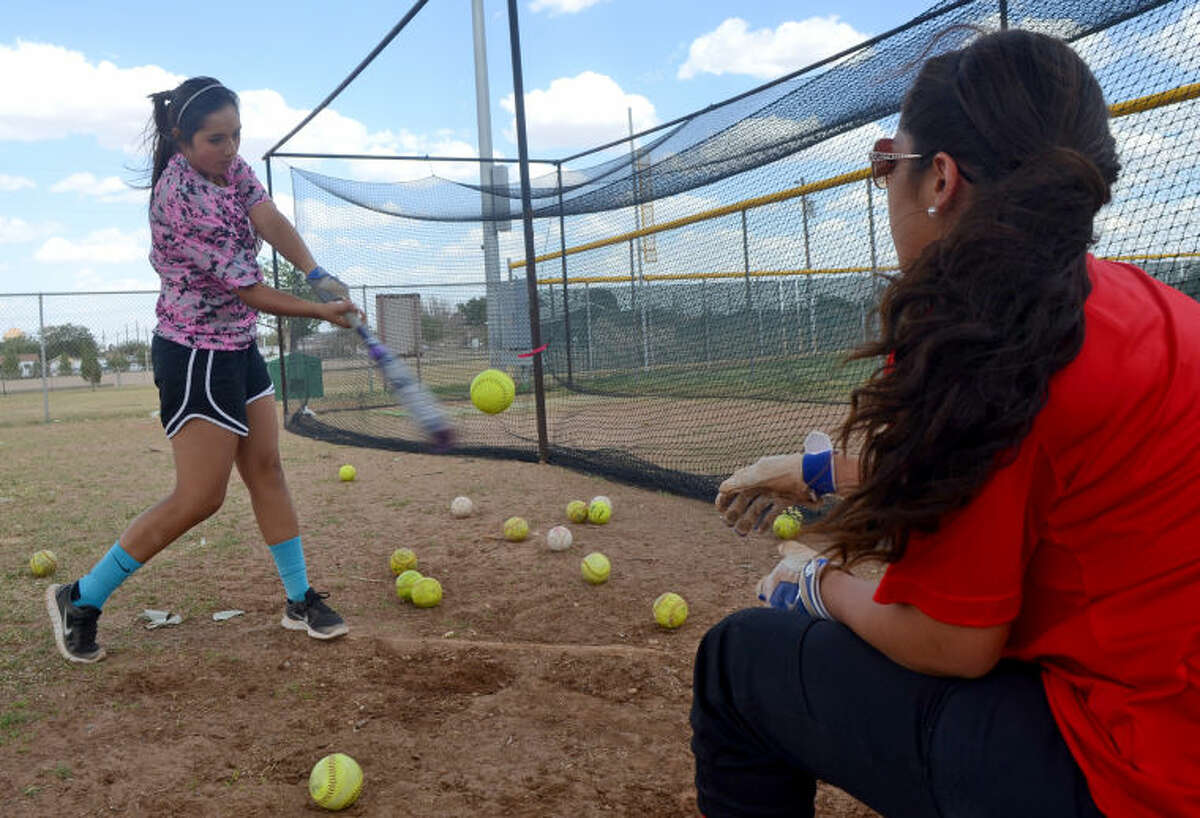 Midland Christian softball players Desiree Gaona (left) and Adrianna Berzoza (right) run through a hitting drill during team practice Wednesday at Freddie Ezell Softball Complex. The Midland Christian softball team heads to the state tournament this weekend. James Durbin/Reporter-Telegram