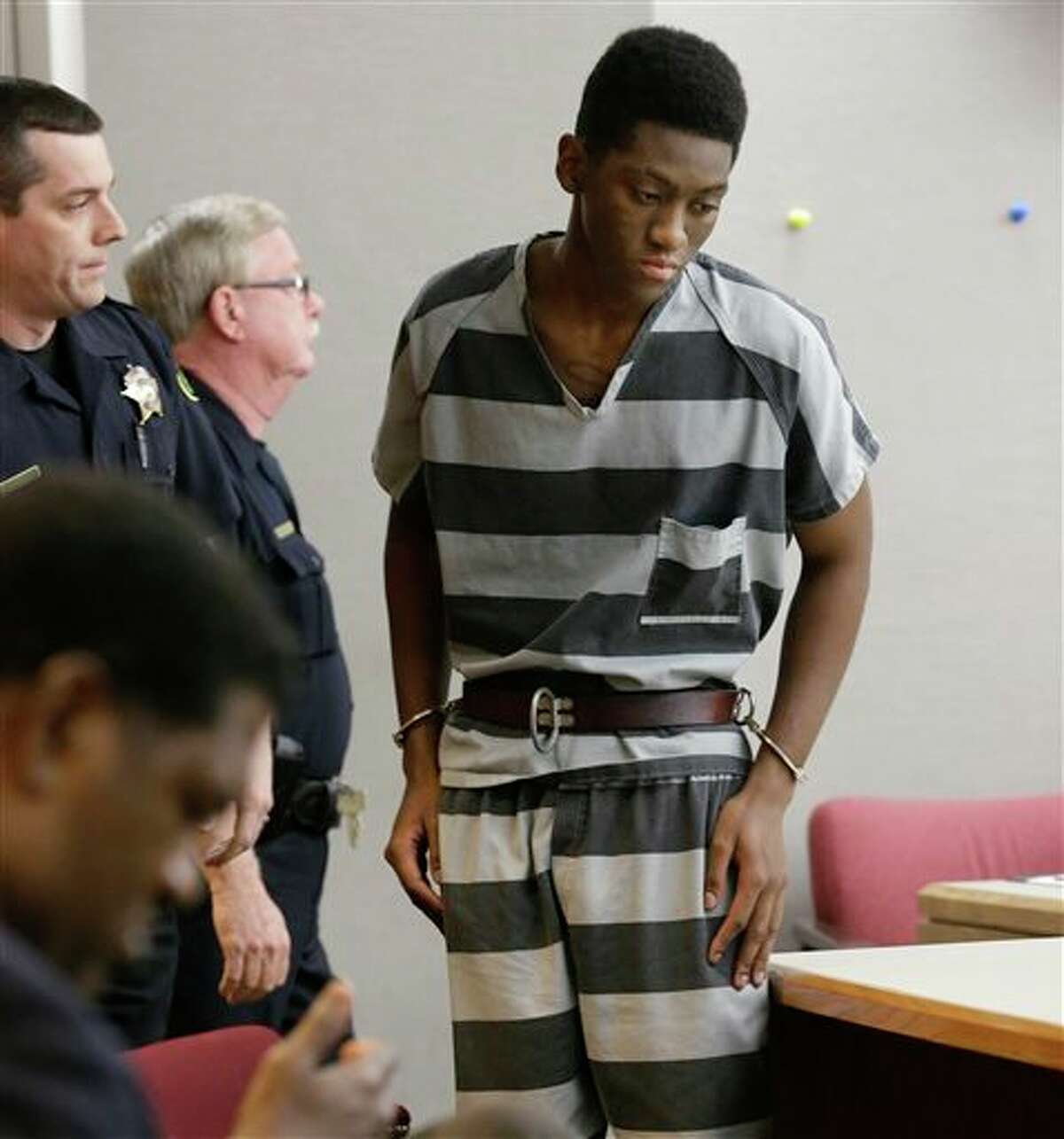 Sir Young, 20, is led into court before a hearing in Dallas Thursday, May 8, 2014. A district court judge has reversed a previous order and imposed a series of probationary requirements for the 20-year-old man convicted of raping a schoolmate. The initial punishment for Young sparked a backlash when a prior judge in Dallas sentenced him to five years of probation and declined to impose standard conditions of probation for sex offenders. (AP Photo/LM Otero)