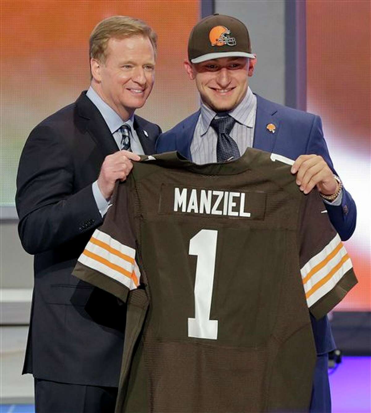 Texas A&M quarterback Johnny Manziel poses with NFL commissioner Roger Goodell after being selected by the Cleveland Browns as the 22nd pick in the first round of the 2014 NFL Draft, Thursday, May 8, 2014, in New York. (AP Photo/Frank Franklin II)