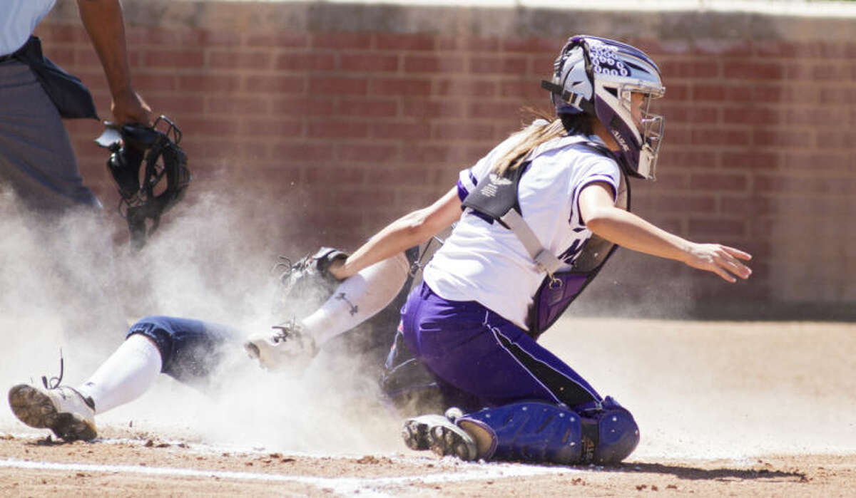 Midland catcher Courtney Warren tags out Richland's Maddi Holcomb during the Bulldogs' 2-0 victory against the Rebels in the UIL Softball Regional Quarterfinals on Friday at Plains Capital Park in Lubbock.