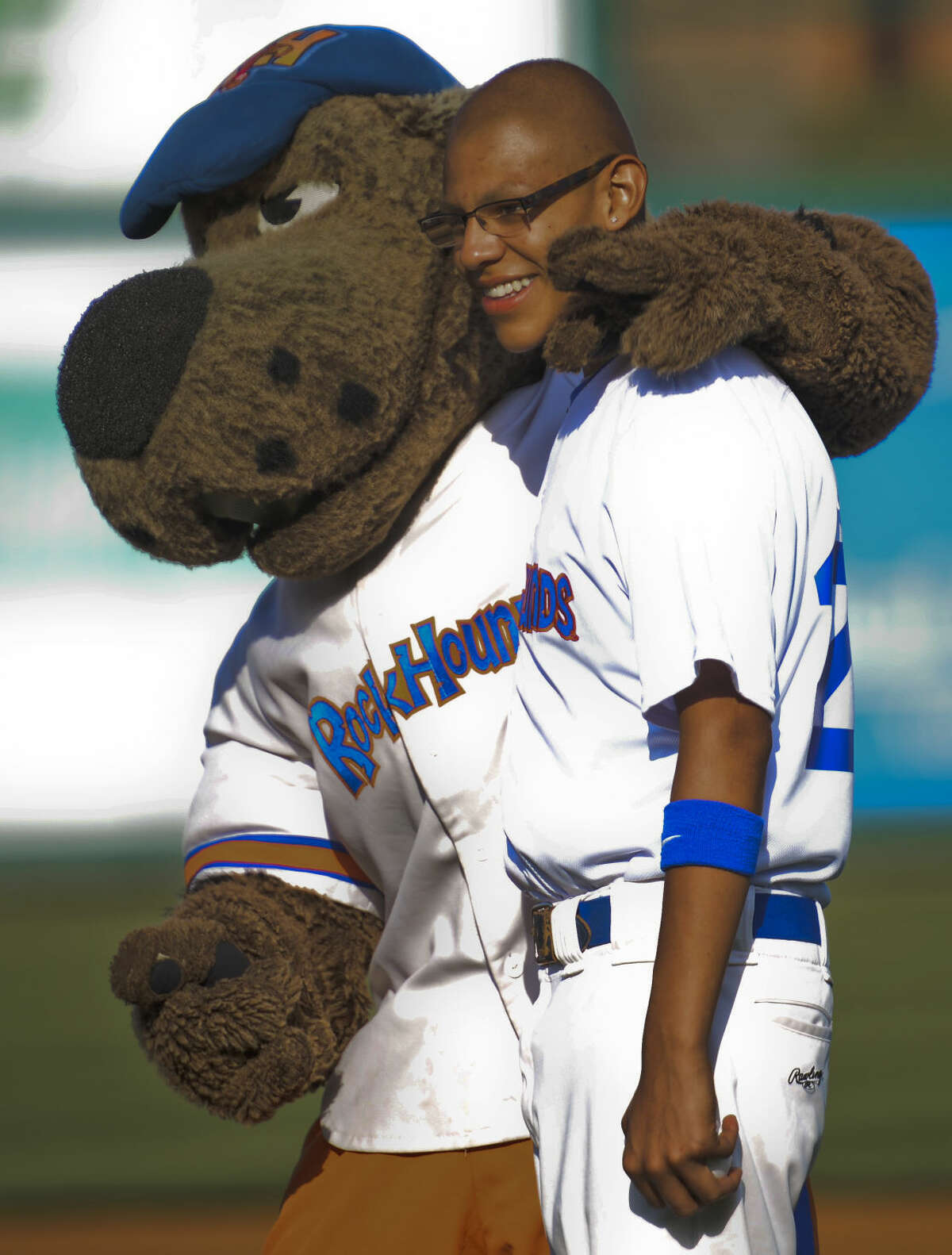 Marcelino Rodriguez, 15, is the newest player for the RockHounds Friday 7-3-15, gets a hug from Rocky before the game. Tim Fischer\Reporter-Telegram