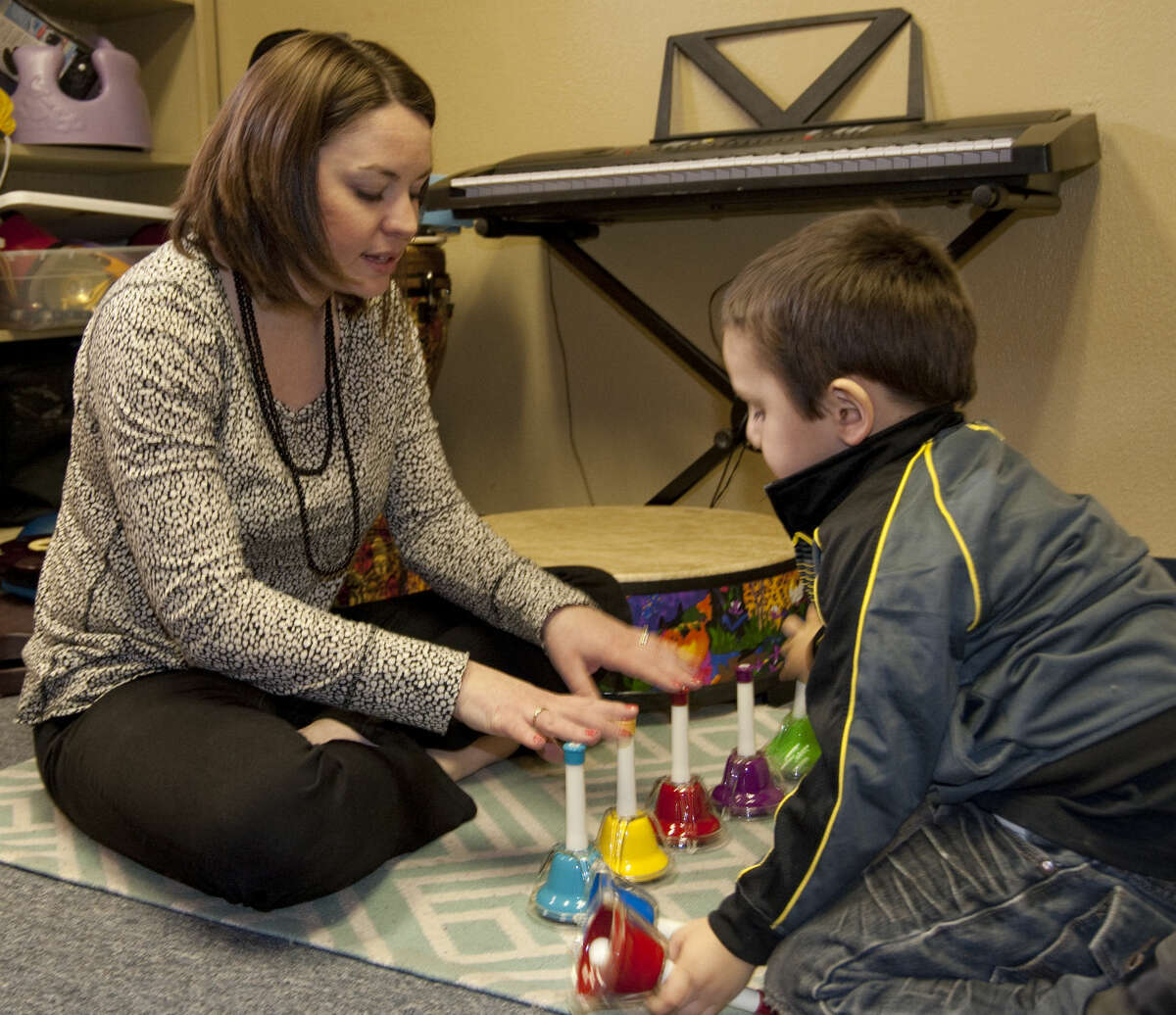 Kayla Minchew uses music with Demetrio Baeza as part of his therapy to learn and use new words. Tim Fischer\Reporter-Telegram