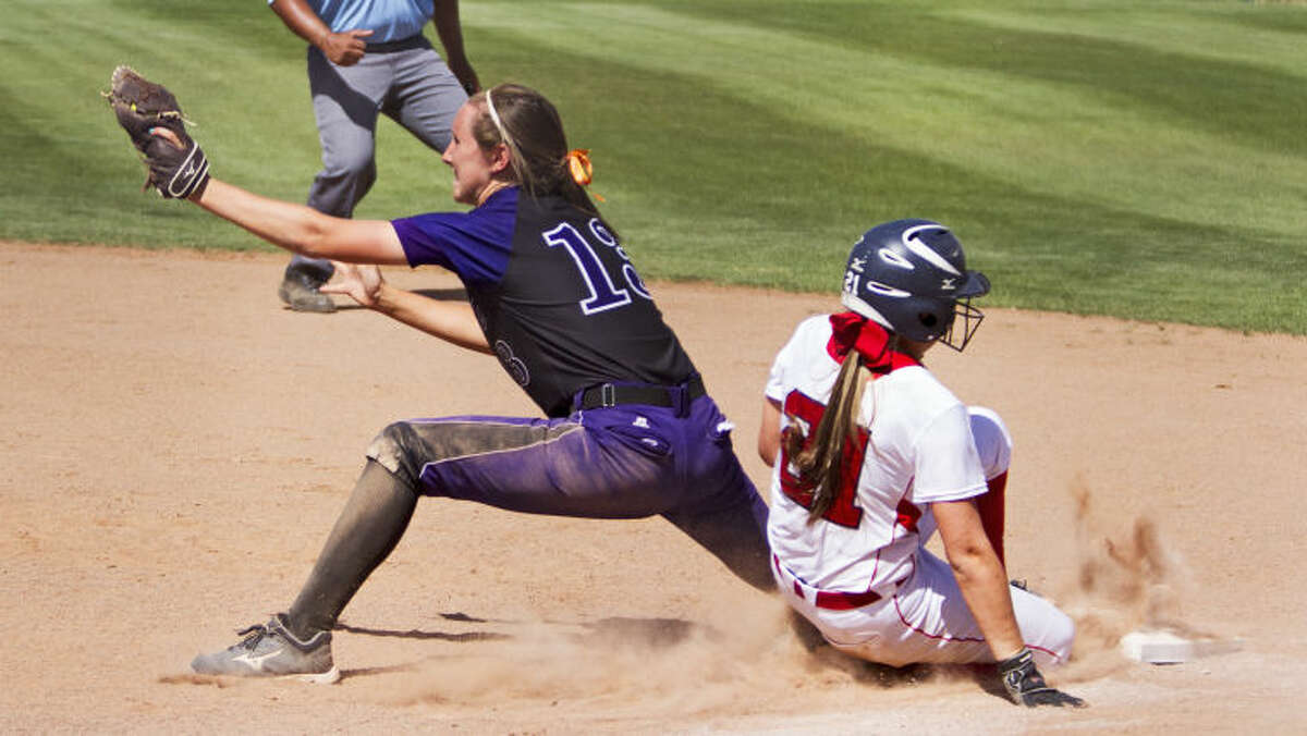 Midland first baseman Aubrie Elliott tags out Richland's Destiny Deaton at first base during the Bulldogs' 12-11 loss against the Rebels in the UIL Softball Regional Quarterfinals on Saturday at Plains Capital Park in Lubbock. The Bulldogs lost the series 2-1 to end their playoff run.