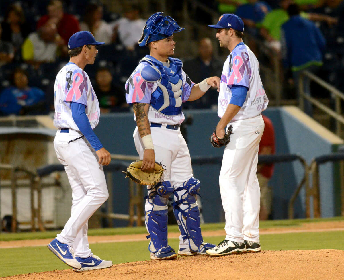 Rockhounds starting pitcher Chris Jensen (right) meets on the mound with catcher Bruce Maxwell (center) and pitching coach John Wasdin (left) during the game against Corpus Christi on Friday, June 12, 2015 at Security Bank Ballpark. James Durbin/Reporter-Telegram