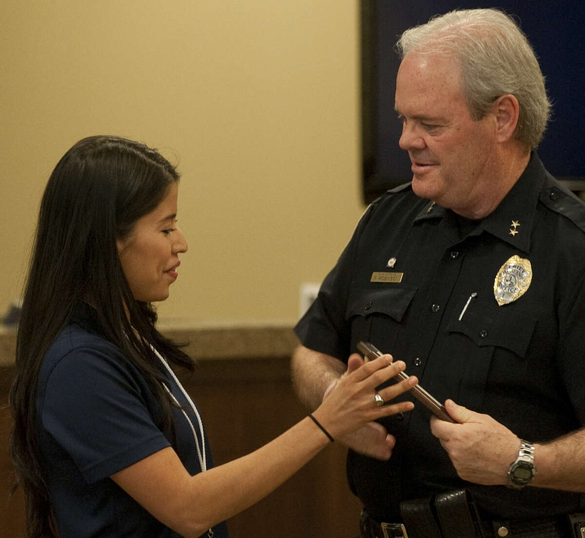 Eliana Samaniego presents Chief Price Robinson with an award in April for MPD's work with the community during the National Crime Victims' Rights Week program. Tim Fischer\Reporter-Telegram