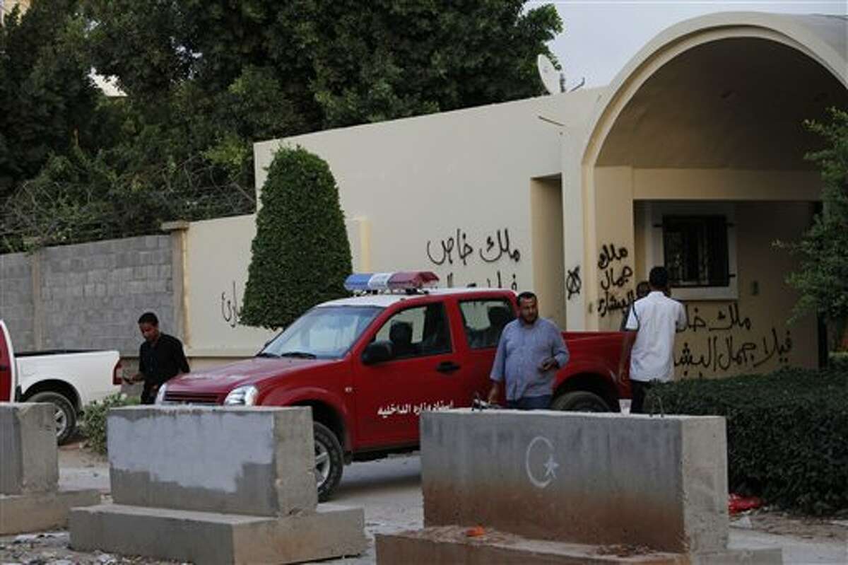 Libyan investigators leave the U.S. Consulate, in Benghazi, Libya Saturday, Sept. 15 2012 after finishing their investigation regarding the attack that killed four Americans, including Ambassador Chris Stevens on the night of Tuesday. The American ambassador to Libya and three other Americans were killed when a mob of protesters and gunmen overwhelmed the U.S. Consulate in Benghazi, setting fire to it in outrage over a film that ridicules Islam's Prophet Muhammad. Ambassador Chris Stevens, 52, died as he and a group of embassy employees went to the consulate to try to evacuate staff as a crowd of hundreds attacked the consulate Tuesday evening, many of them firing machine-guns and rocket-propelled grenades. (AP Photo/Mohammad Hannon)