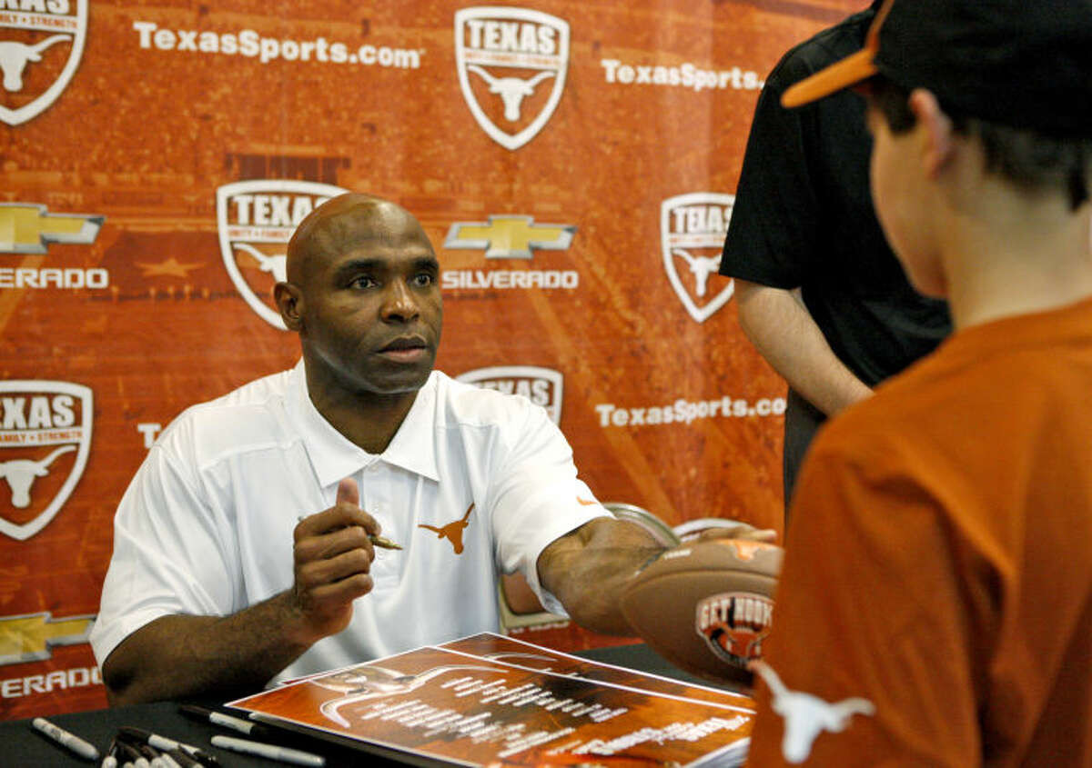 University of Texas head football coach Charlie Strong signs autographs during a stop in Midland on the "Texas Comin' on Strong Tour" Tuesday at the CAF. James Durbin/Reporter-Telegram