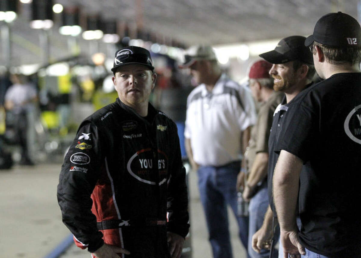 Midlander Tyler Young talks with friends after finishing 19th in the NASCAR Camping World Truck Series WinStar World Casino 400 Friday, June 7 at Texas Motor Speedway. James Durbin/Reporter-Telegram