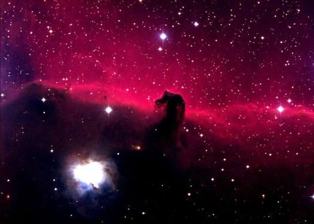 Lying just below the belt of Orion, the Horsehead Nebula is actually two nebulae, one lying in front of the other. The foreground nebula, which includes the horsehead figure, appears dark because there are no nearby stars to illuminate it. The background nebula emits the characteristic red light of hydrogen, caused to glow by the energy of nearby stars. The Horsehead is also known as IC 434. This image was made with the 0.8-meter Telescope at McDonald Observatory, with the Prime Focus Corrector instrument. Credit: Tom Montemayor/McDonald Observatory