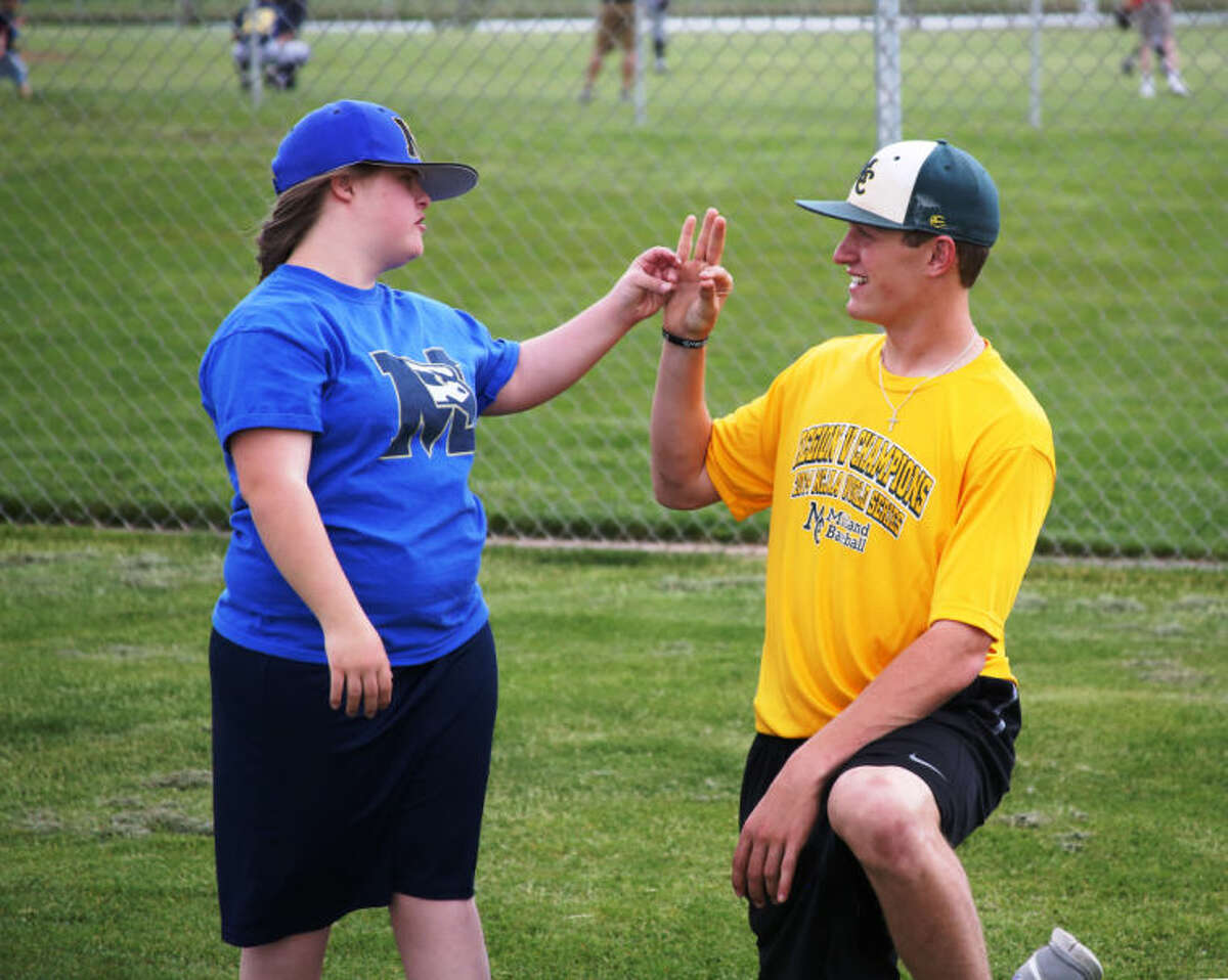 MC Baseball player Daniel Crooks works with a player during the Challenger Baseball program in Grand Junction, Colo., on Thursday. Forrest Allen/MC Athletics