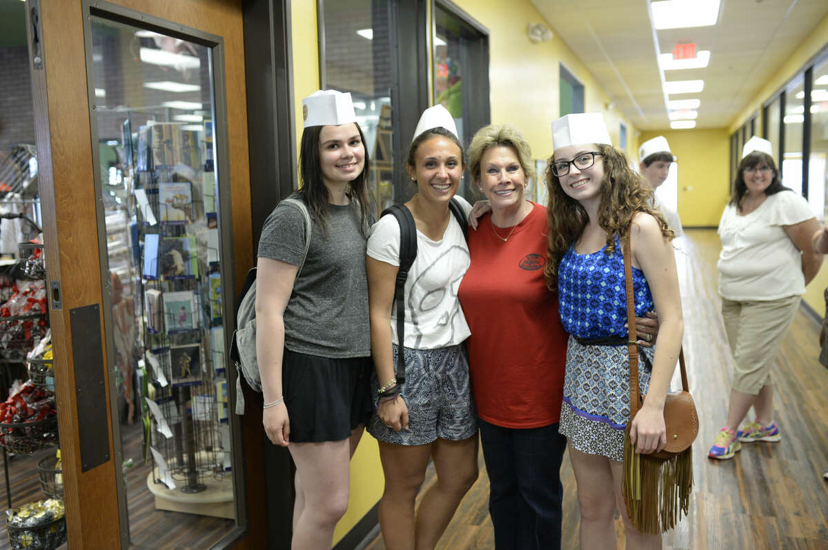 Susie Hitchcock-Hall, owner of Susie's South Forty, poses for a picture with Downtown Lion's Club exchange students from left, Sanni Saarelainen of Finland, Alessia Martini of Italy, and Luana Gasperotto of Brazil (far right) during a visit to Susie's South Forty on Friday, July 10, 2015. James Durbin/Reporter-Telegram