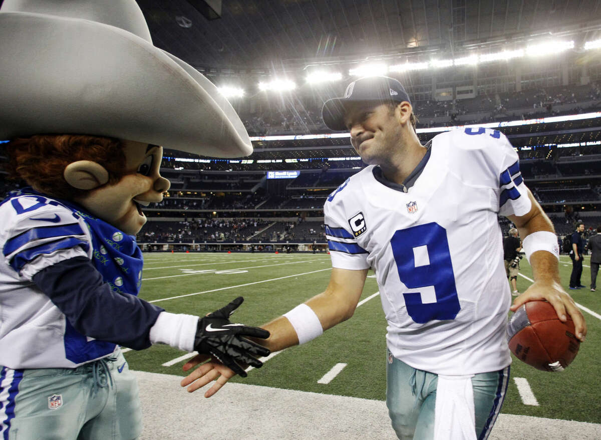 Dallas Cowboys quarterback Tony Romo (9) celebrates with team mascot Rowdy after defeating the Philadelphia Eagles 38-33 in an NFL football game Sunday, Dec. 2, 2012 in Arlington, Texas. (AP Photo/Tony Gutierrez)