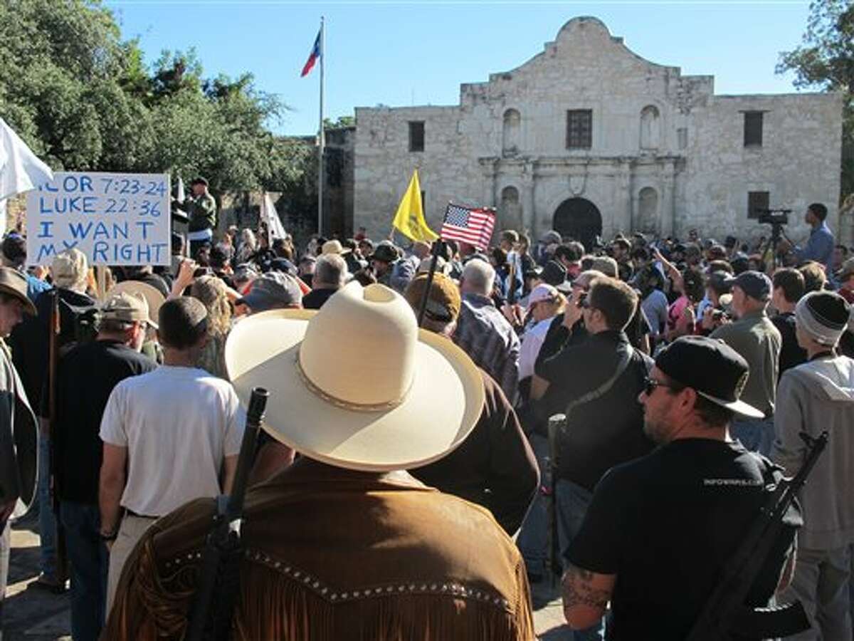 (File Photo) Gun rights advocates gather at the Alamo in San Antonio, Texas on Oct. 19, 2013 to demonstrate in support of a Texas law that permits the open carry of long arms, such as rifles and shotguns. Organizers said a local ordinance restricting the carrying of firearms in public conflicts with state law. (AP Photo/Christopher Sherman)