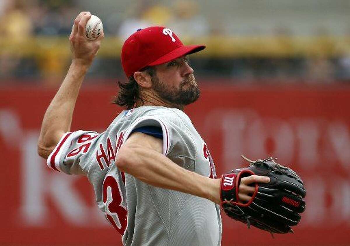 In this June 14, 2015, file photo, Philadelphia Phillies starting pitcher Cole Hamels delivers in the first inning of a baseball game against the Pittsburgh Pirates in Pittsburgh. Two people familiar with the deal say the Phillies have agreed to trade Hamels to the Texas Rangers for a package of prospects. Both people spoke to The Associated Press late Wednesday night, July 29, 2015, on condition of anonymity because the trade has not been finalized. Hamels has a limited no-trade clause but does not have to approve a deal to the Rangers.