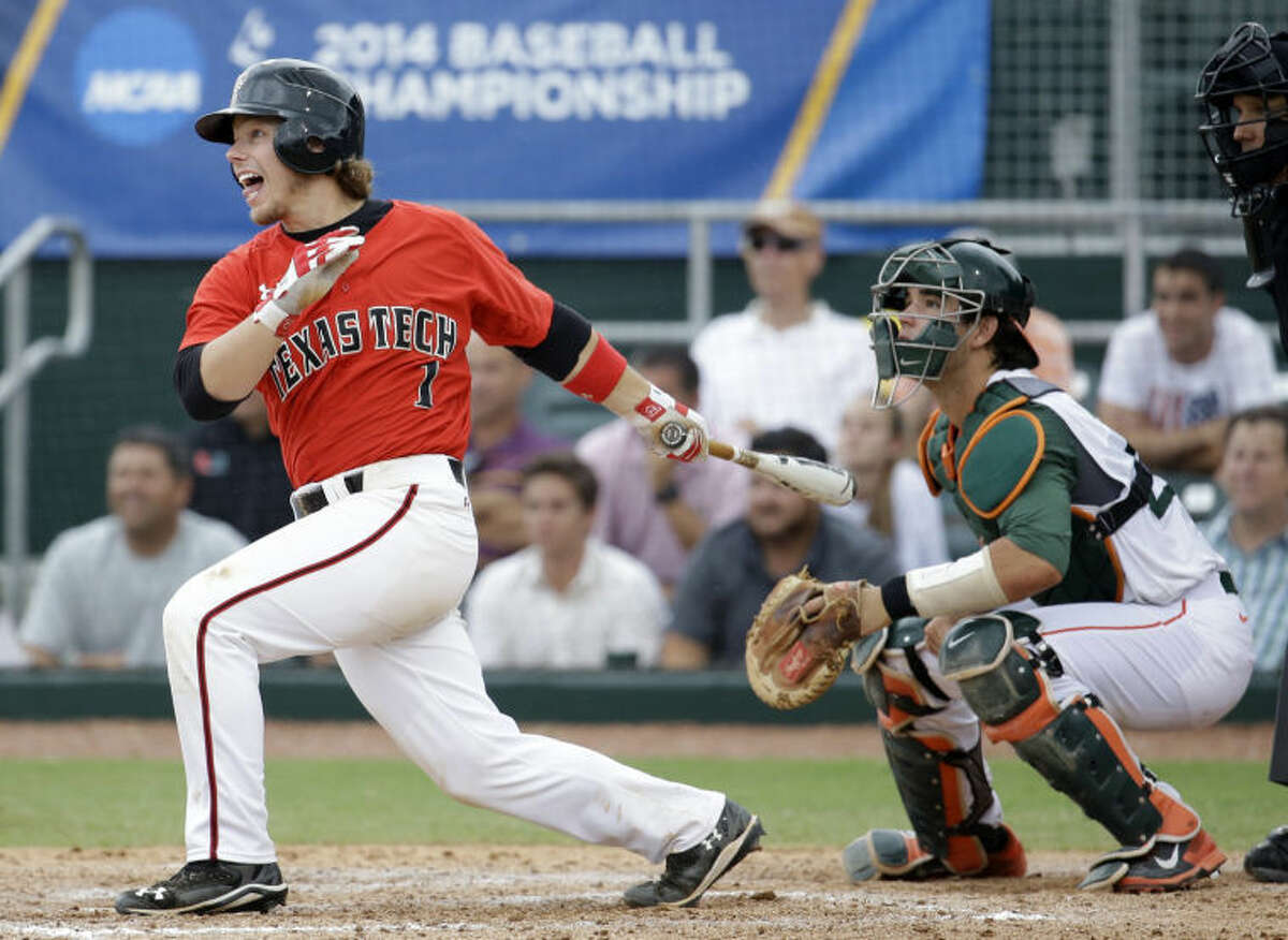 Texas Tech's Tim Proudfoot (1) follows through on a single as Miami catcher Garrett Kennedy looks on in the seventh inning during an NCAA college baseball regional tournament in Coral Gables, Fla., Monday, June 2, 2014. Texas Tech defeated Miami 4-0 to advance to the Super Regionals. (AP Photo/Lynne Sladky)