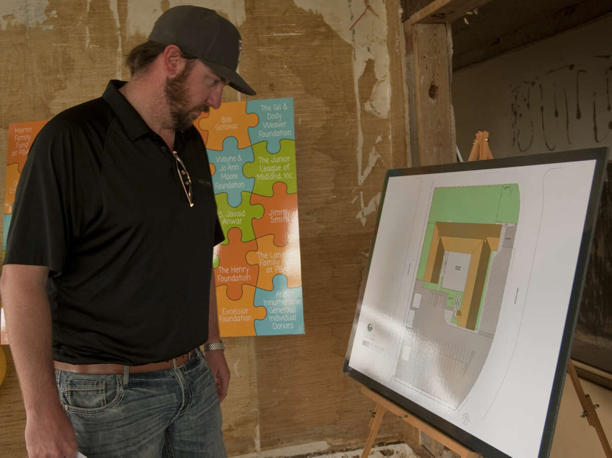 Jacob Tyler, with construction company Pharr & Company, looks over some of the initial drawings Thursday, 5-28-15, at the new building for Centers for Children and Families as they have completed their capital campaign to renovate the new property on Andrews Hwy. Tim Fischer\Reporter-Telegram