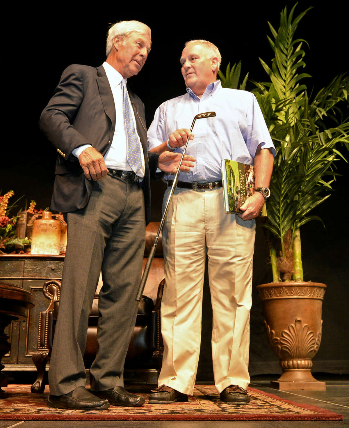 Golf legend Ben Crenshaw presents an autographed used game putter to Peter Courtney, president of H.L. Brown Operating, after selling it as a surprise auction item during the Centers for Children and Families annual fundraiser dinner banquet Thursday, August 6, 2015 at Horseshoe Pavilion. James Durbin/Reporter-Telegram