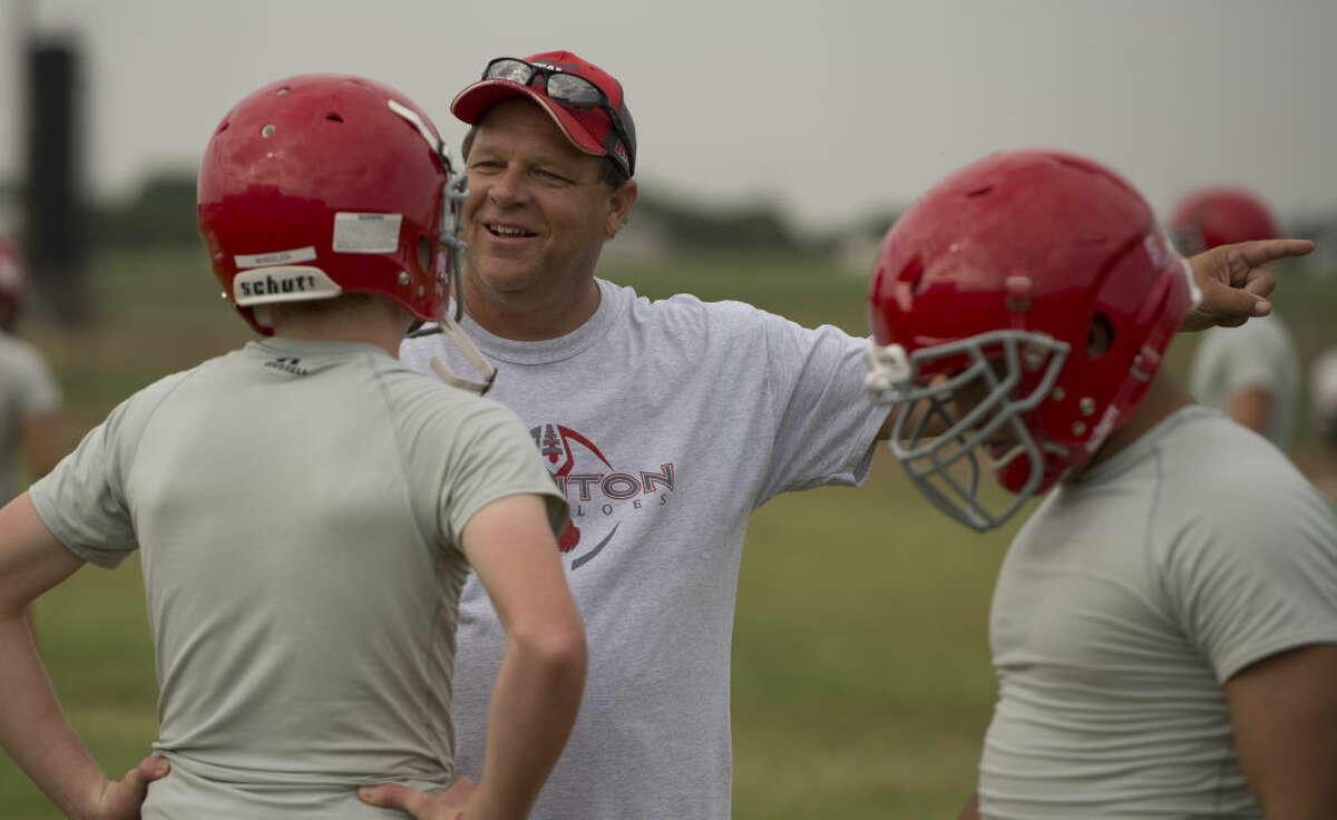 Stanton head coach John Peterson talks with his players as they run drills Tuesday 8-4-15, during the first week of football practice. Tim Fischer\Reporter-Telegram