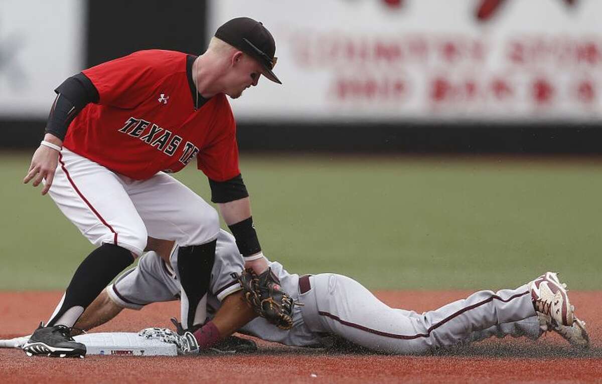 College of Charleston's Champ Rowland slides safely into second base ahead of the tag by Texas Tech's Bryant Burleson, left, during a NCAA college baseball tournament super regional game in Lubbock, Texas, Saturday, June 7, 2014. (AP Photo/Lubbock Avalanche Journal, Shannon Wilson)